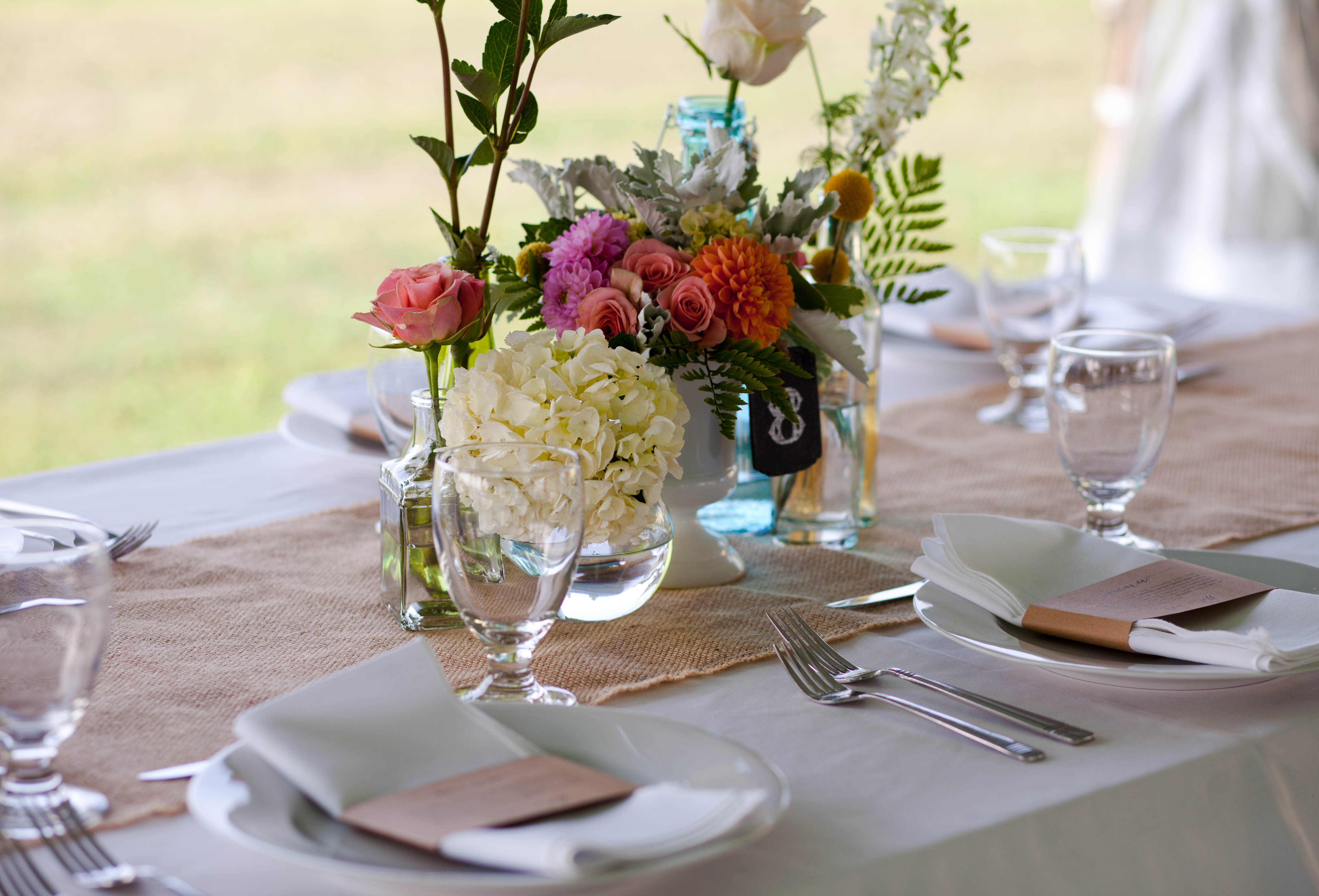 a plate topped with a vase of flowers on a table