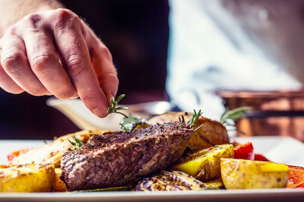 a close up of a person holding a plate of food