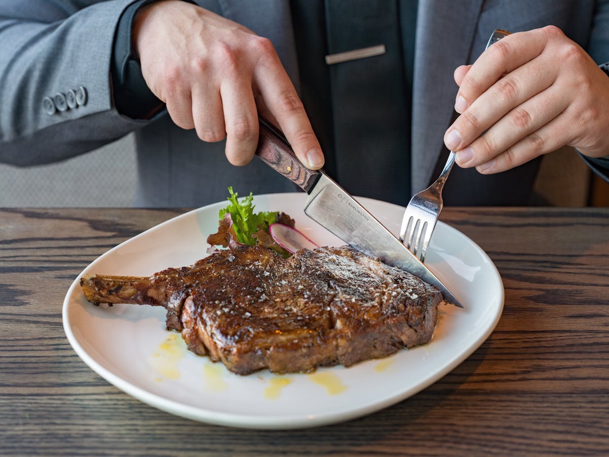 a person sitting at a table with a plate of food