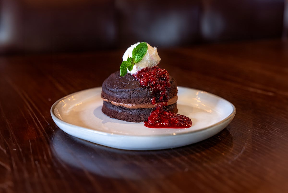 a piece of chocolate cake with raspberry sauce