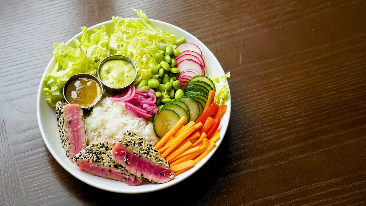 rice bowl with fresh vegetables and seared tuna