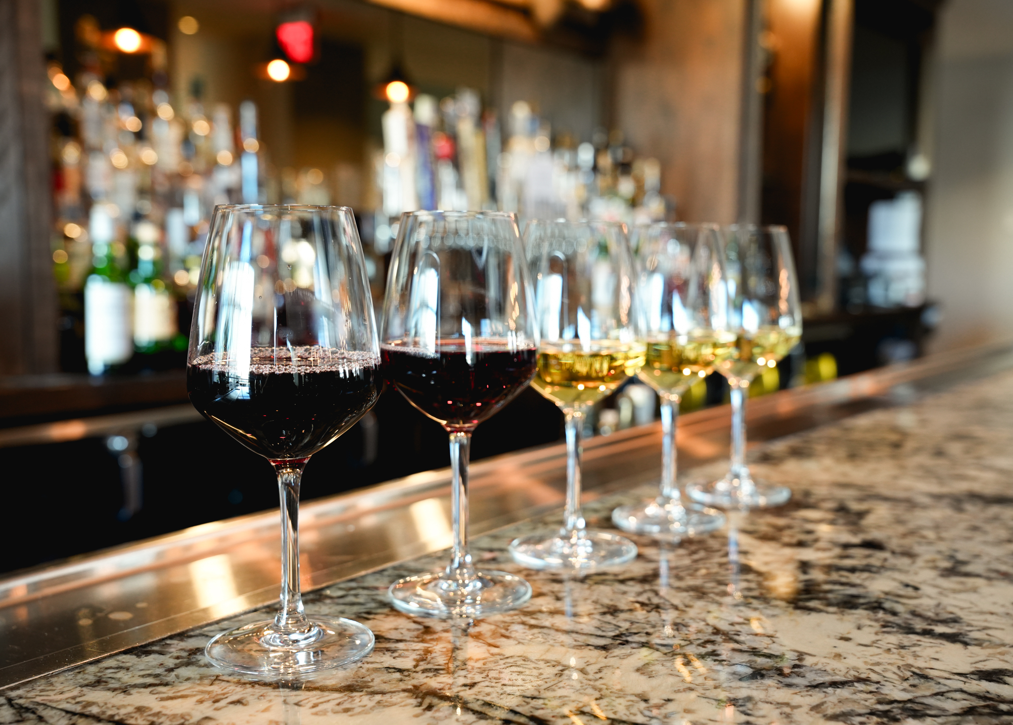a row of wine glasses on a counter