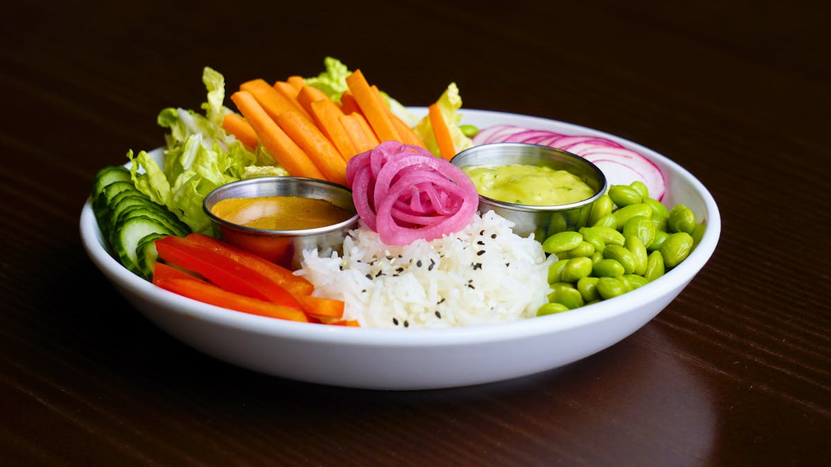 jasmine rice bowl topped with fresh vegetables