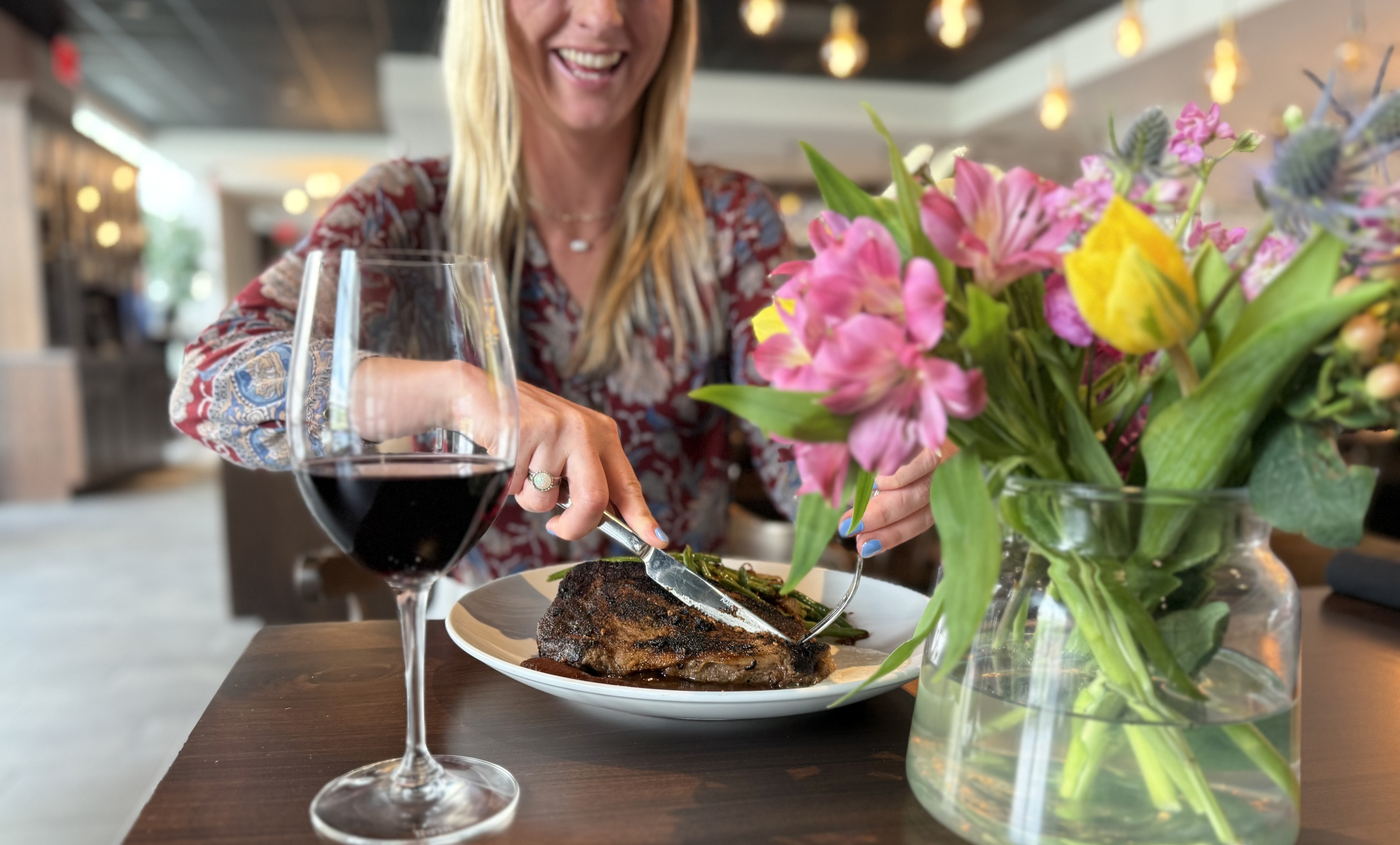 a woman cutting a piece of meat