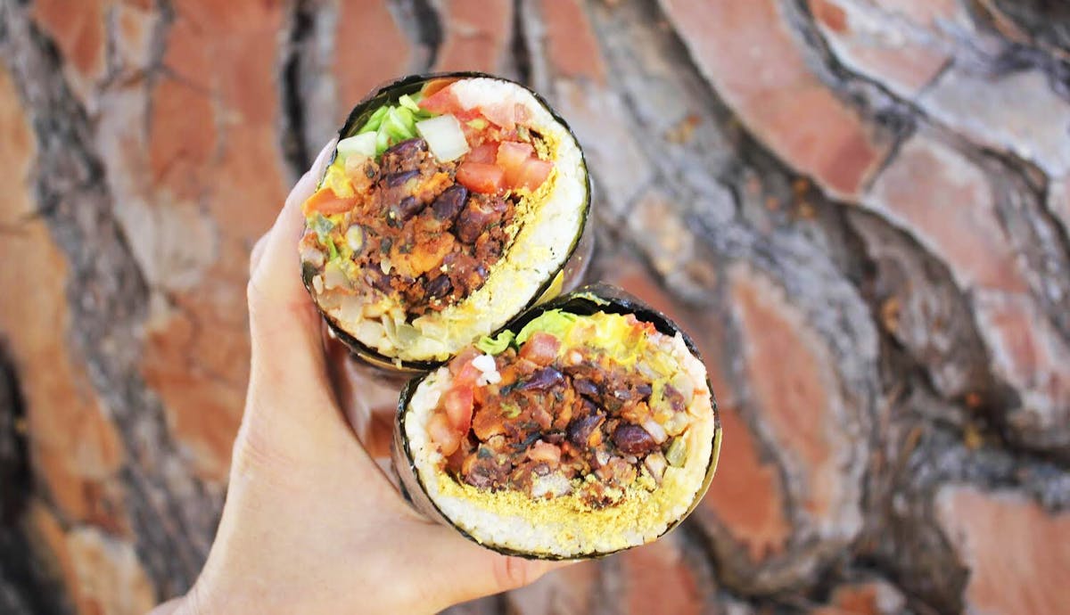 a close up of a person holding a piece of food