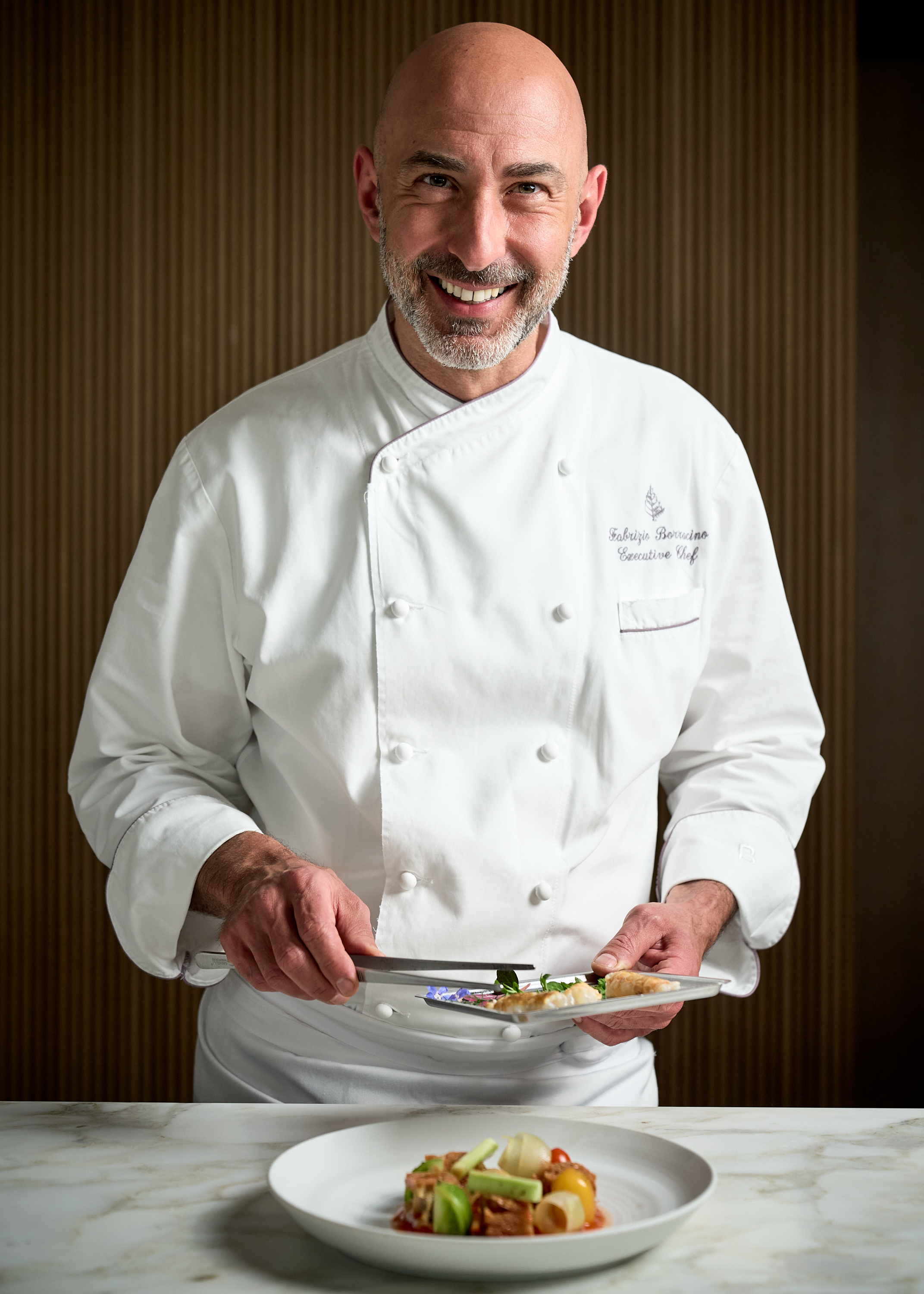 a man sitting at a table with a plate of food