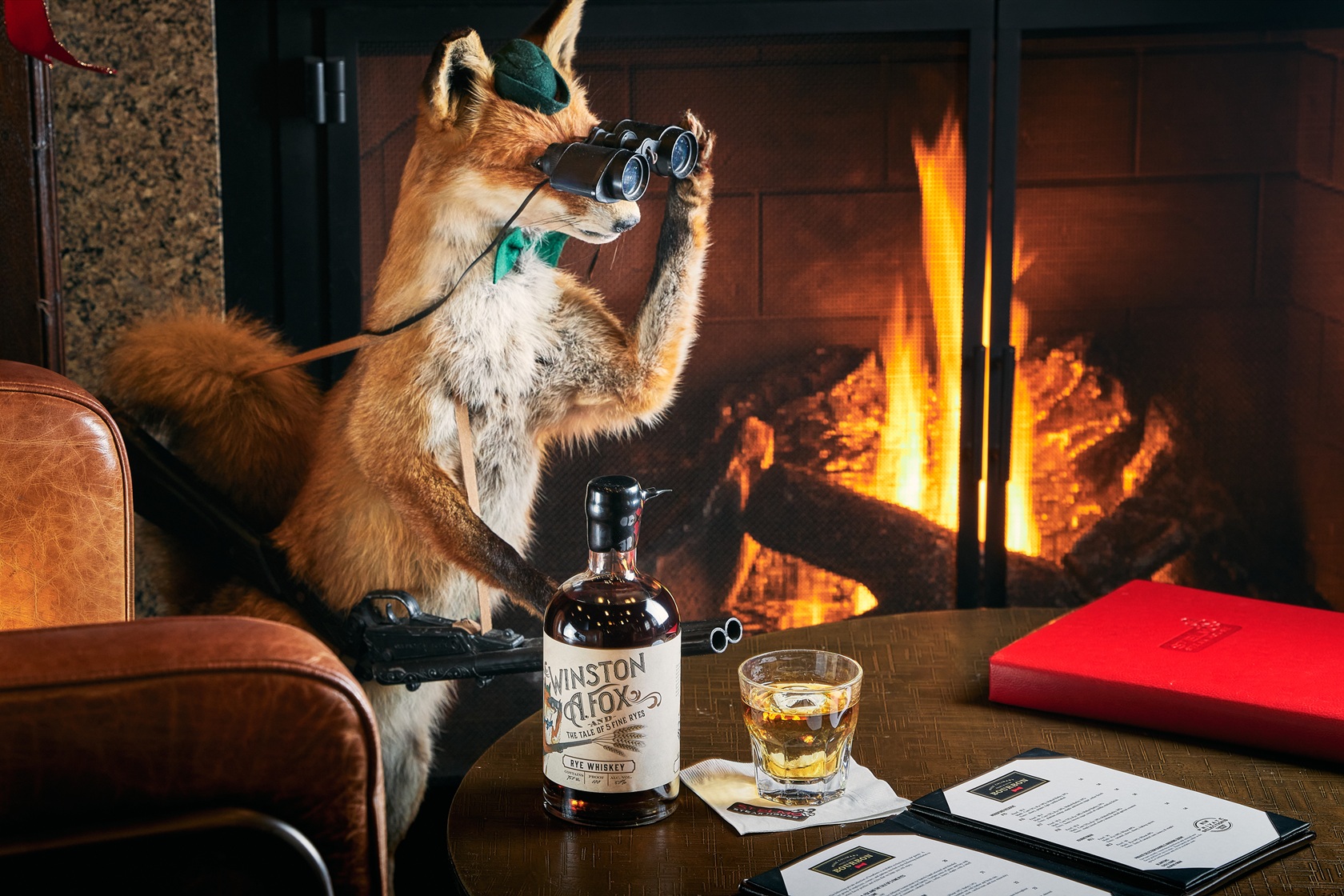 Winston A. Fox peering through binoculars while sitting in front of a burning fireplace.