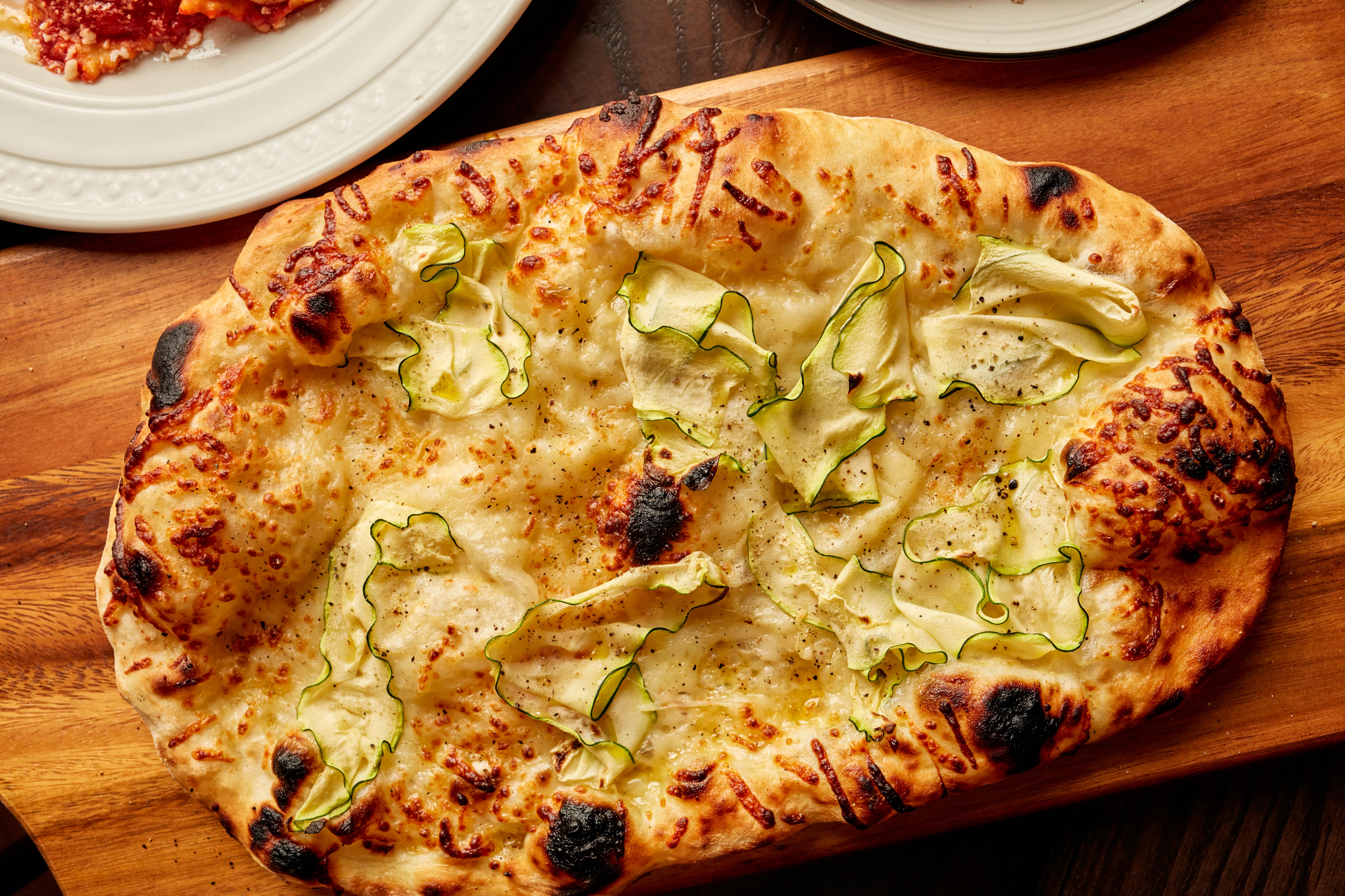 a slice of pizza sitting on top of a wooden table