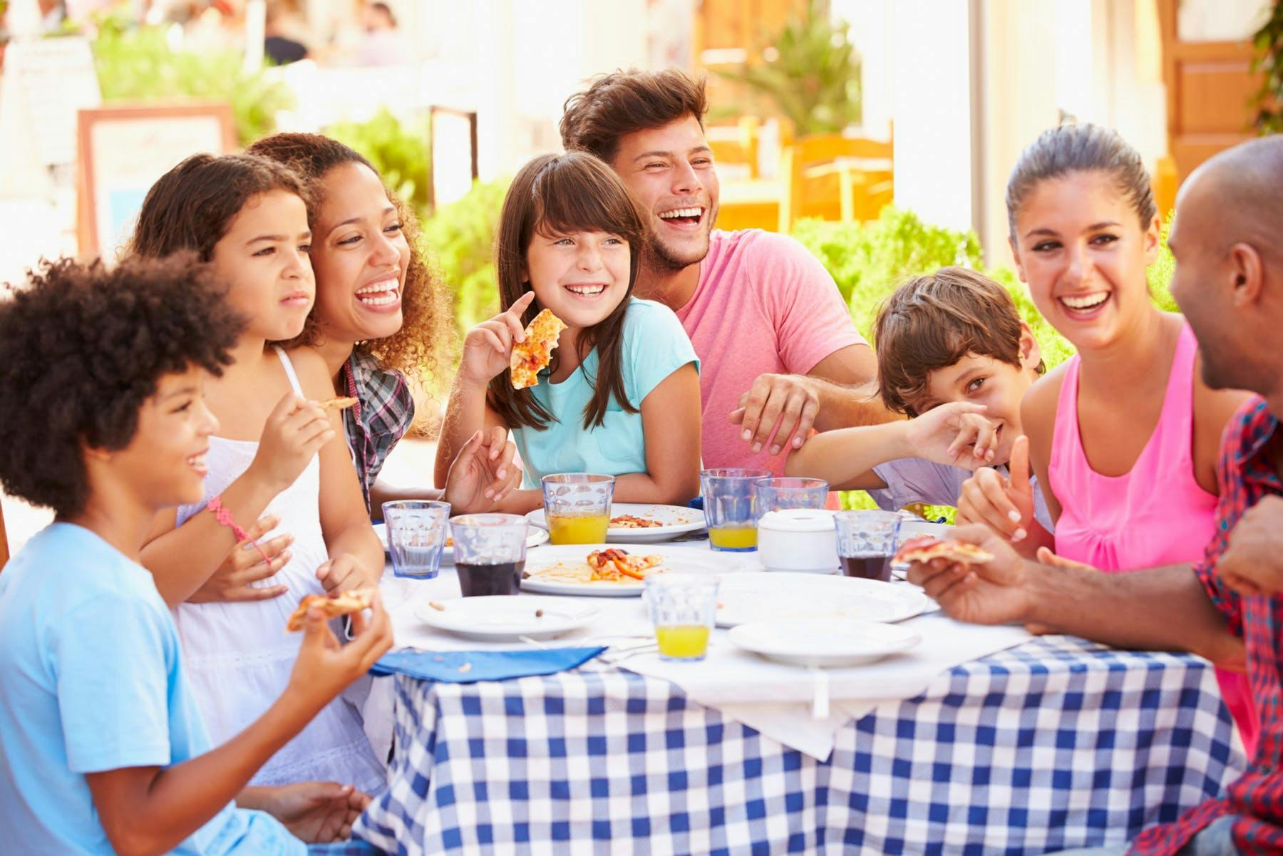 a group of people sitting down at a picnic table