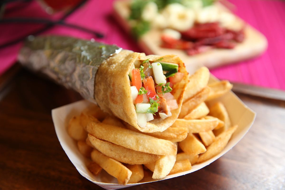a wrap and fries on a plate