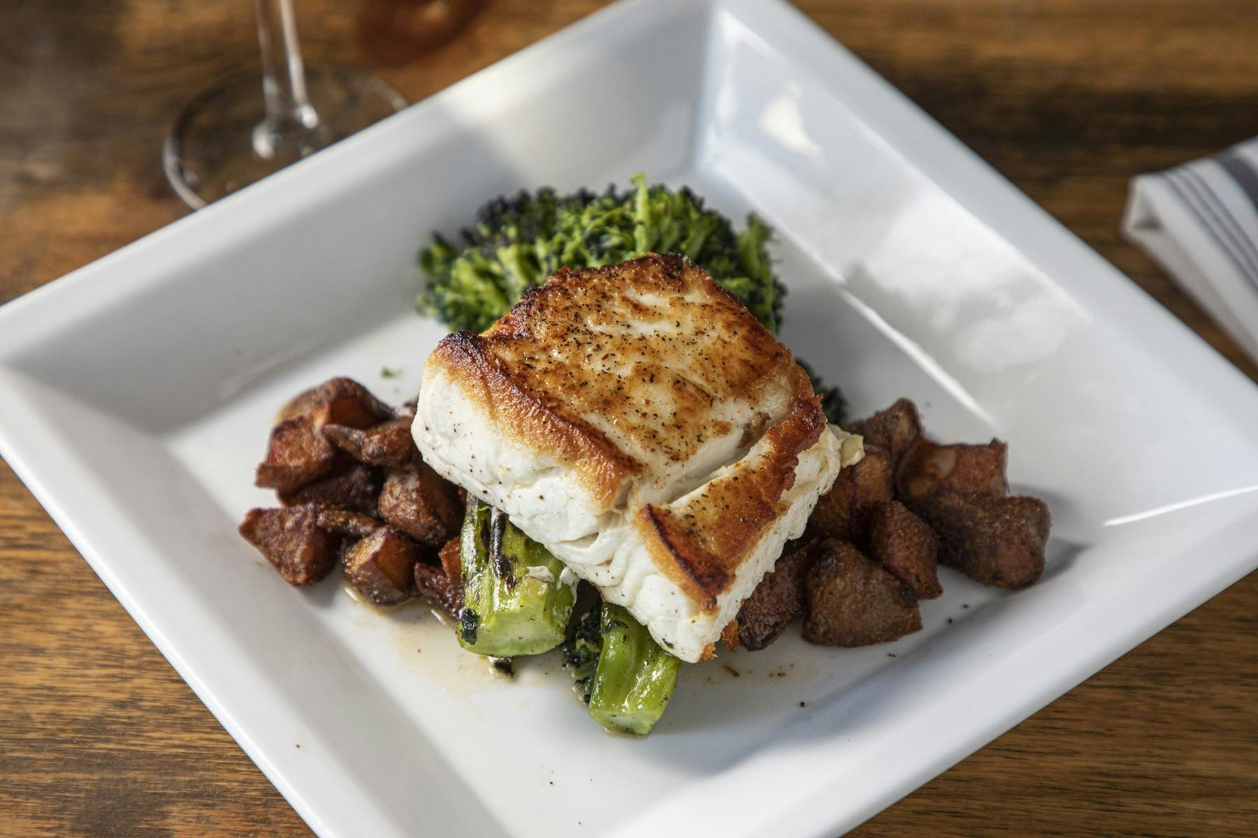 a plate of fish and steak