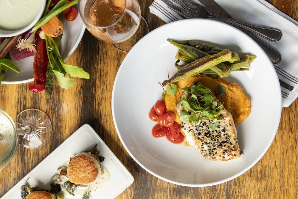 a plate of chicken and vegetables on a table