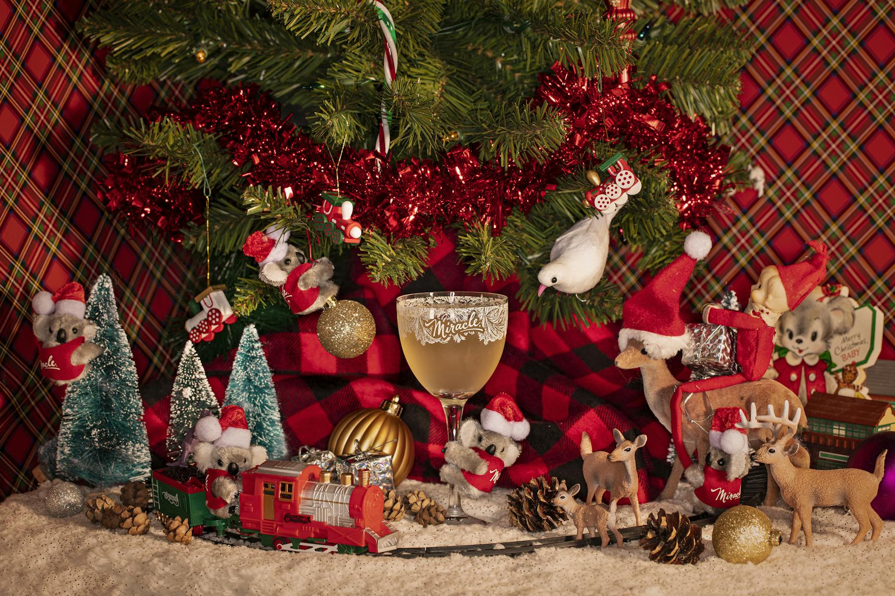 a group of stuffed animals sitting next to a christmas tree