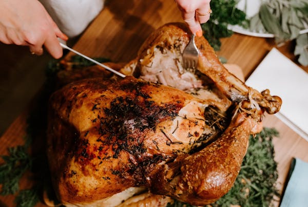 a close up of a person cutting a piece of food