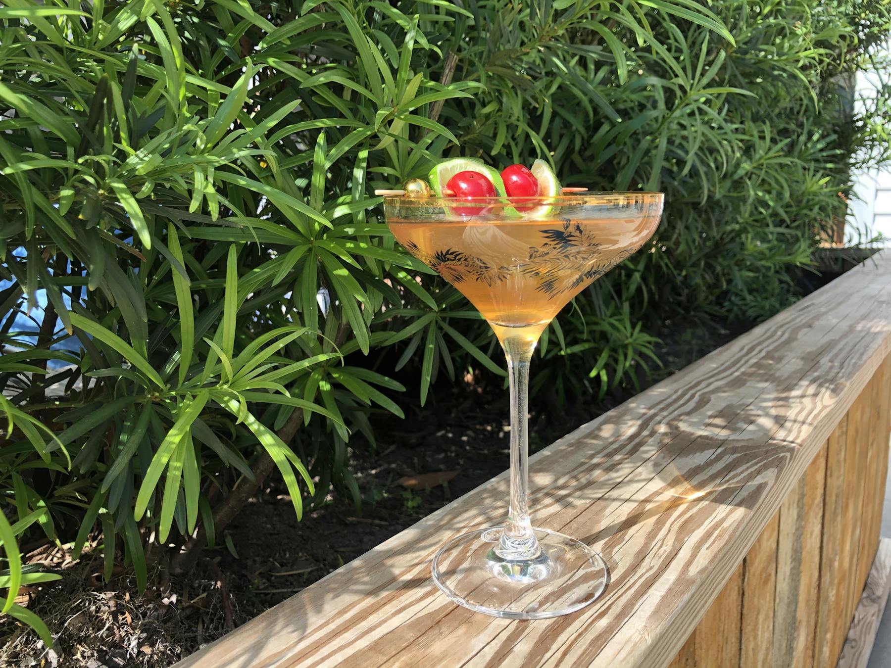 a glass of wine sitting on top of a wooden table