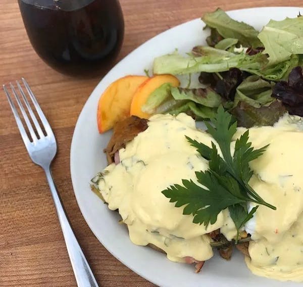 a white plate topped with a salad and a fork