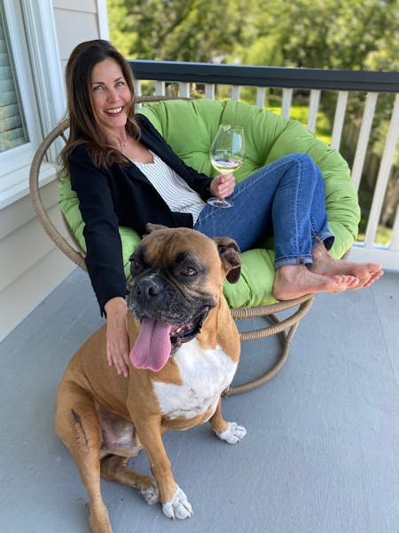 a woman sitting on a bench with a dog