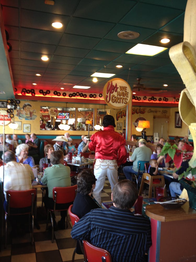 a group of people sitting at a table in a restaurant