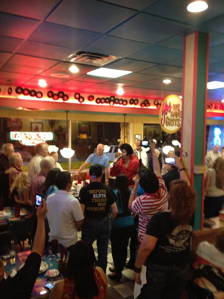 a group of people standing in front of a store