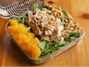 a dish is filled with food sitting on top of a wooden table