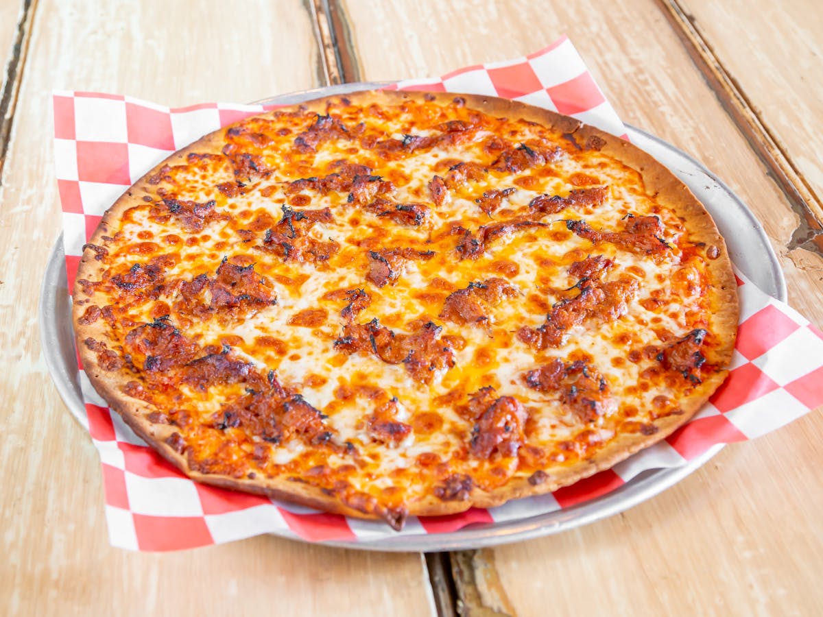 a pizza sitting on top of a wooden table