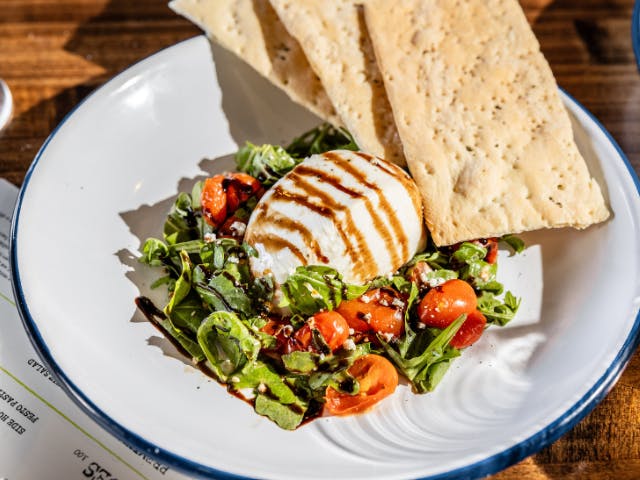 Burrata salad with a side of crackers