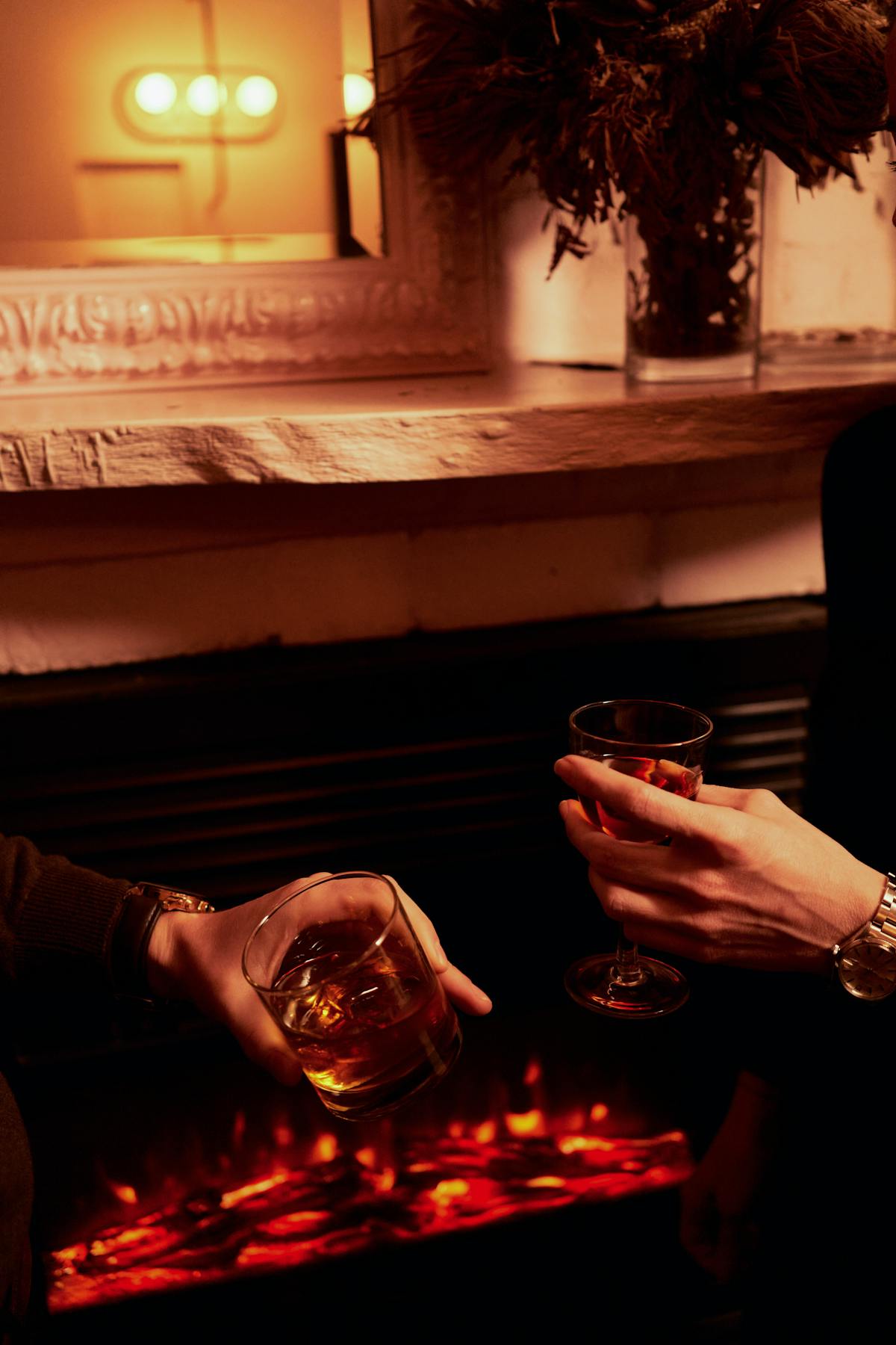 a person sitting at a table with wine glasses