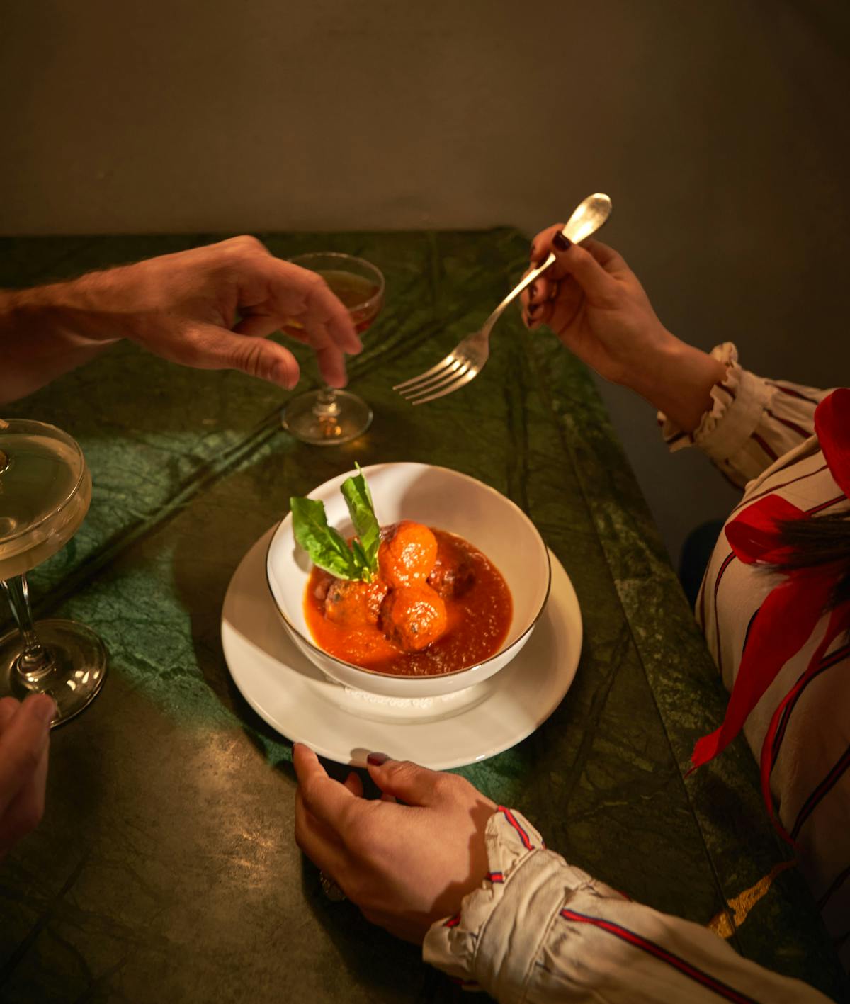 a woman sitting at a table with a plate of food