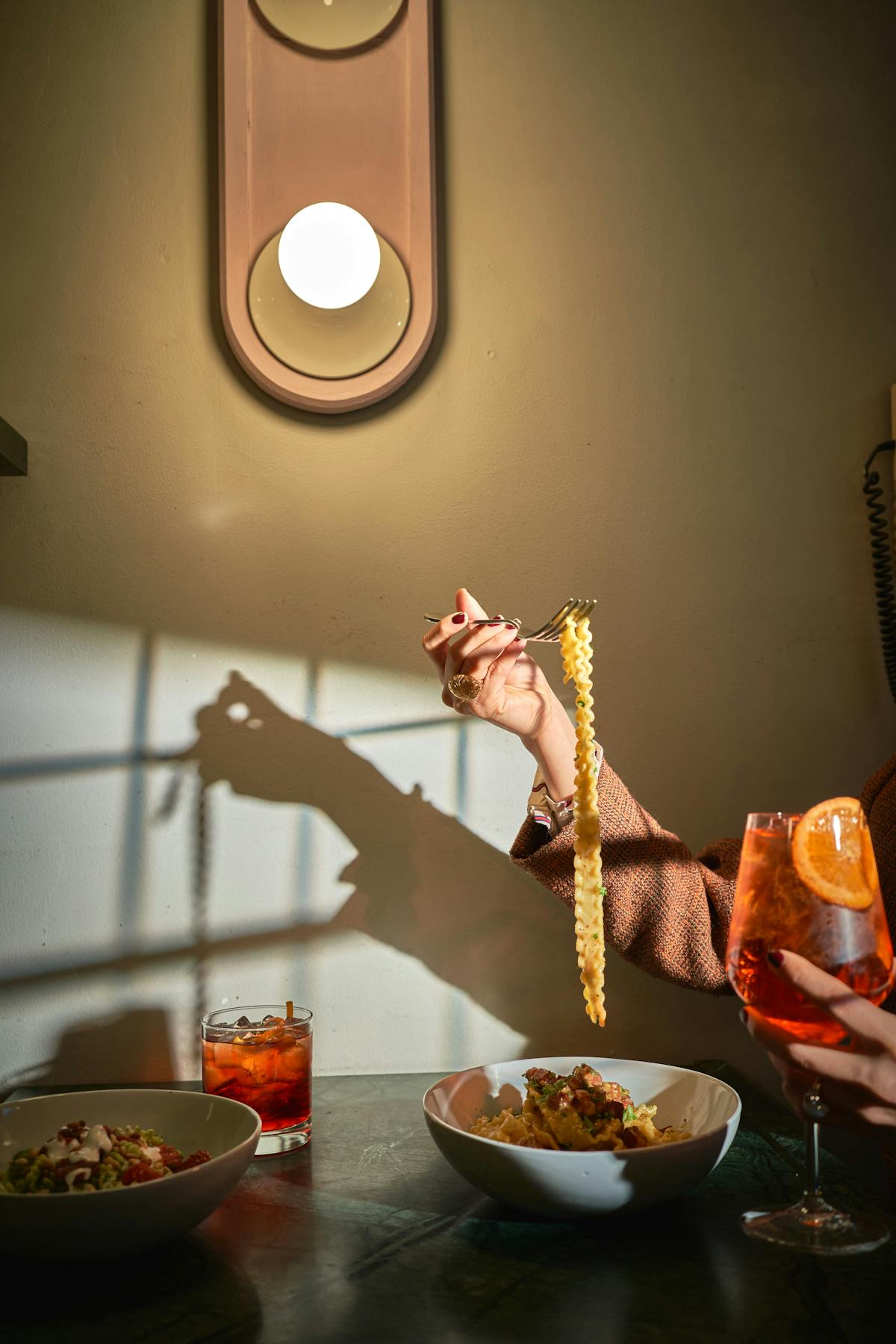 a person sitting at a table with a plate of food