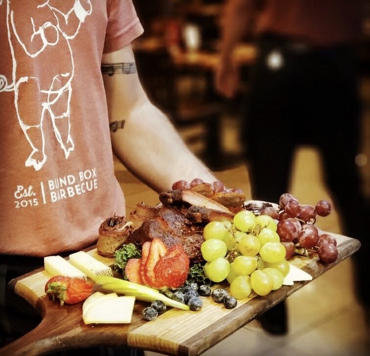 a person that is cutting some food on a table