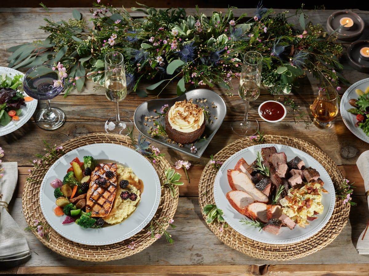 a group of people sitting at a table with a plate of food