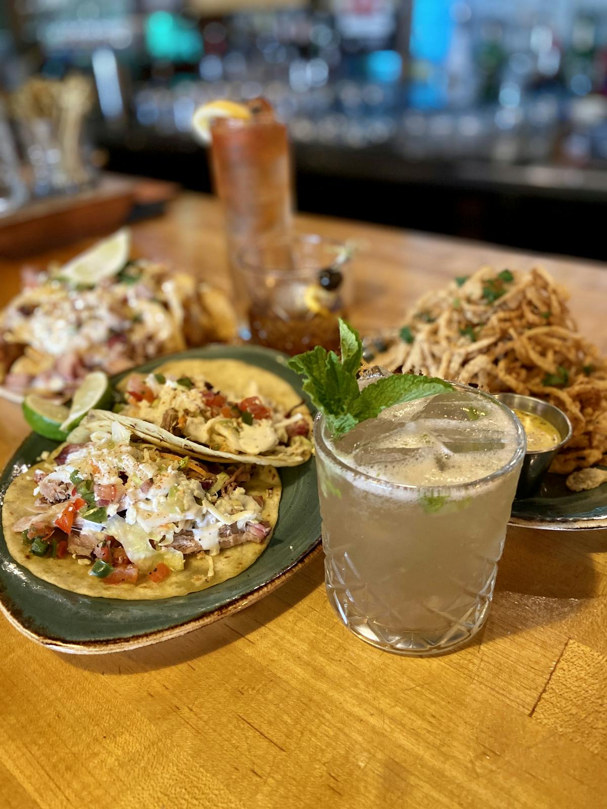 plates of food and a cocktail on a table
