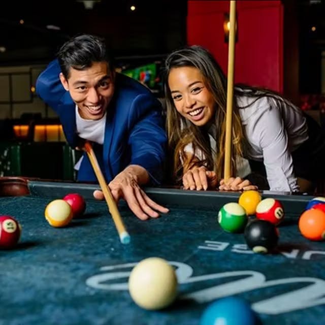 a group of people sitting at a table with a blue ball