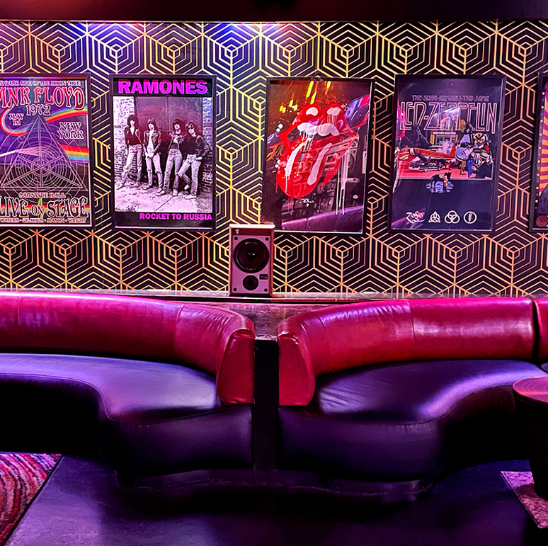 a group of people sitting in a chair talking on a cell phone