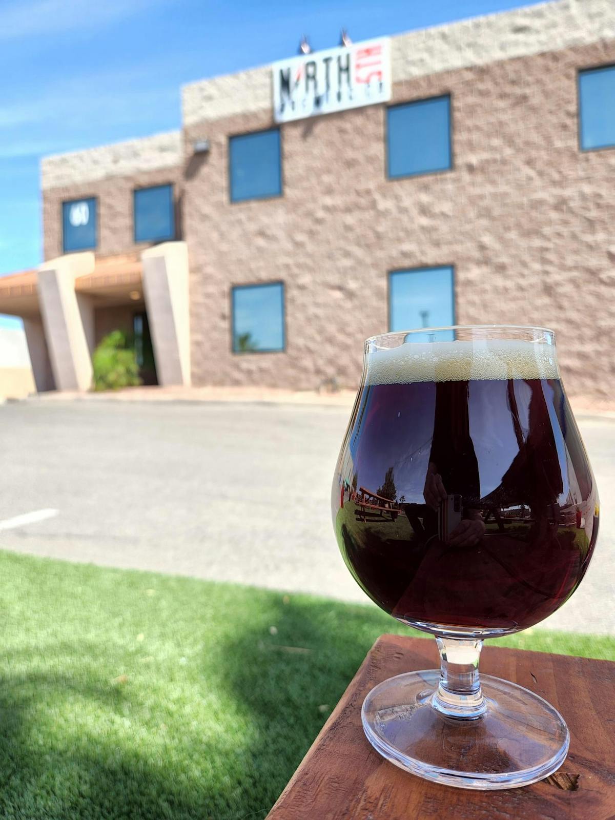 a glass of wine in front of a building