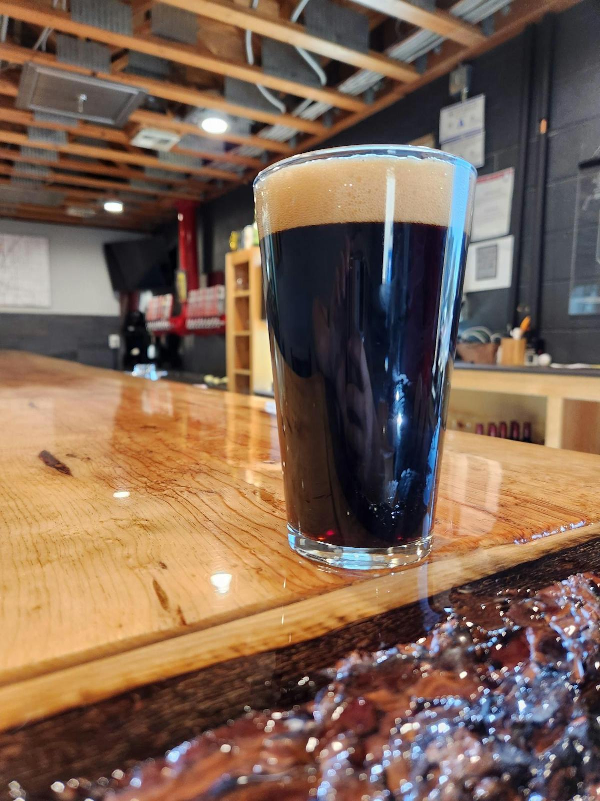 a glass of beer on a wooden table