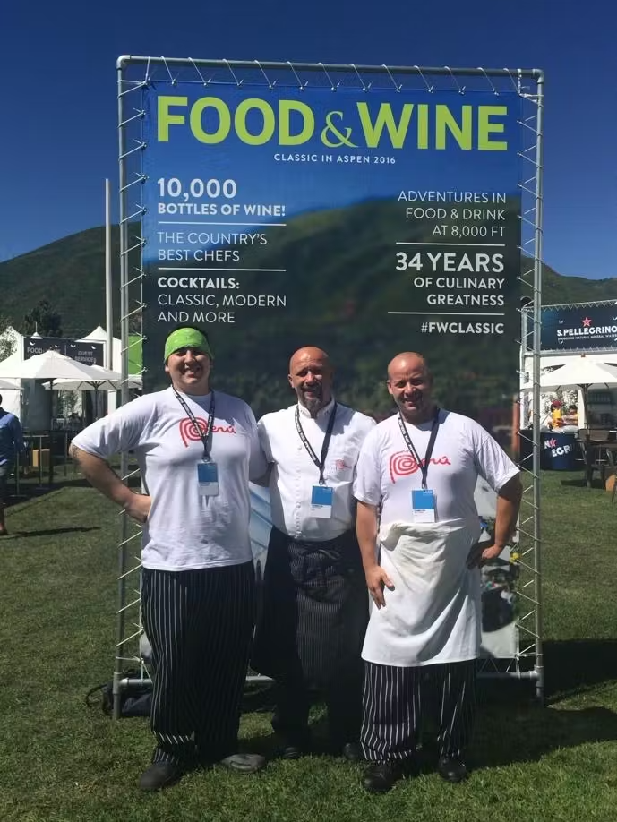 a group of people holding a sign posing for the camera