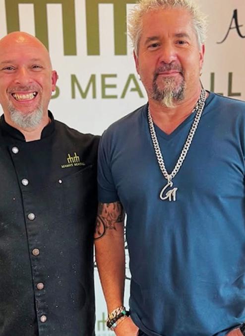 Guy Fieri et al. posing for the camera