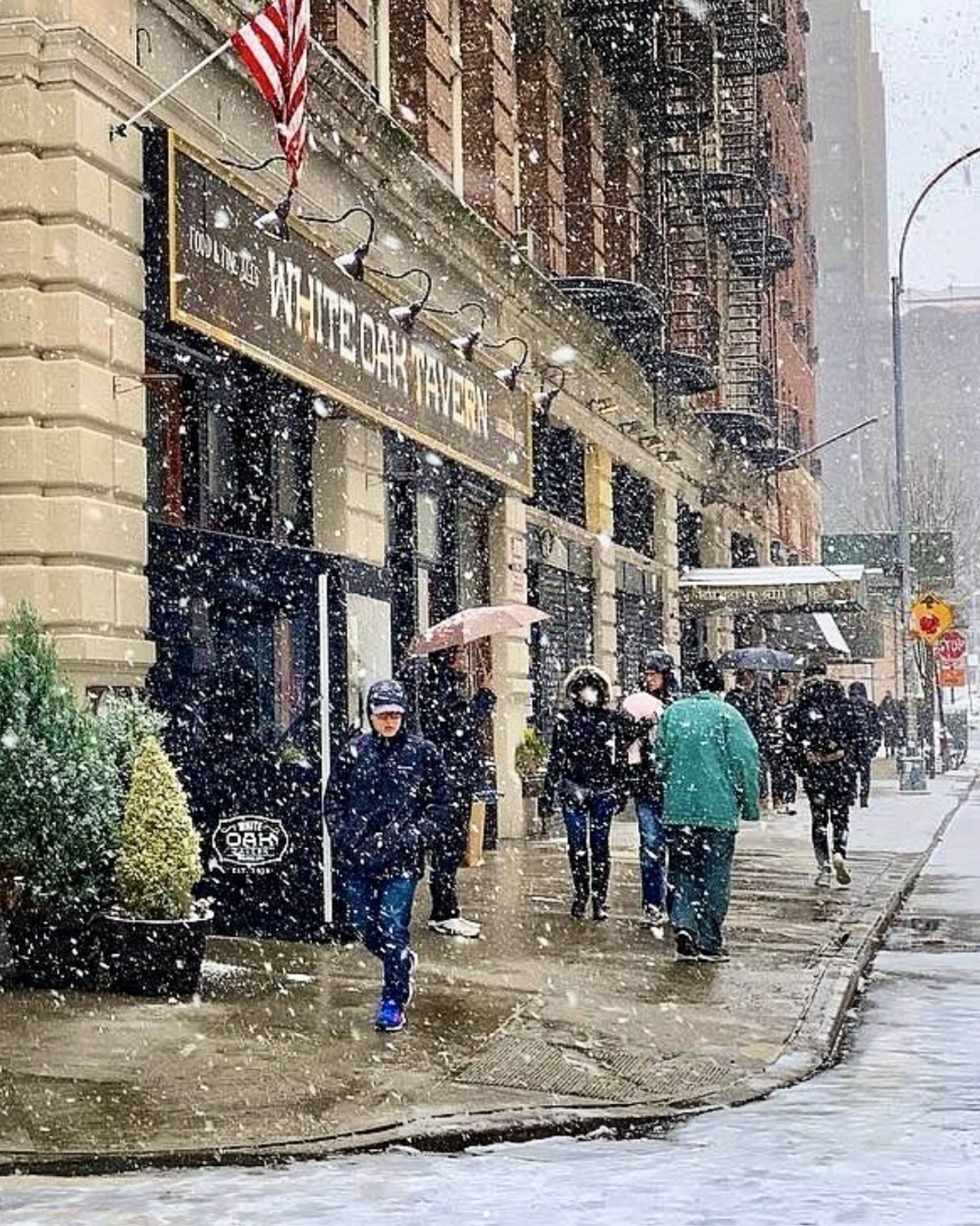 snow covered sidewalk with people