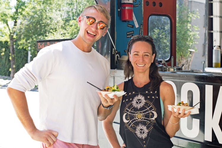 Guests posing for a photo and holding the ordered food