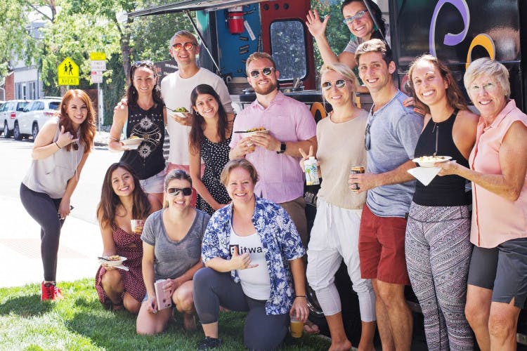 Customers posing for a photo in front of the foodtruck