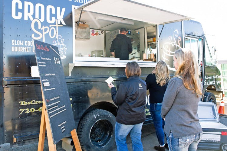 Guests waiting in a line in front of the food truck