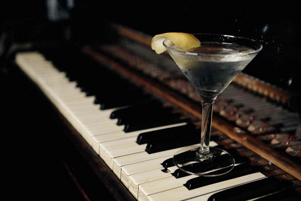 a piano with a cocktail on top