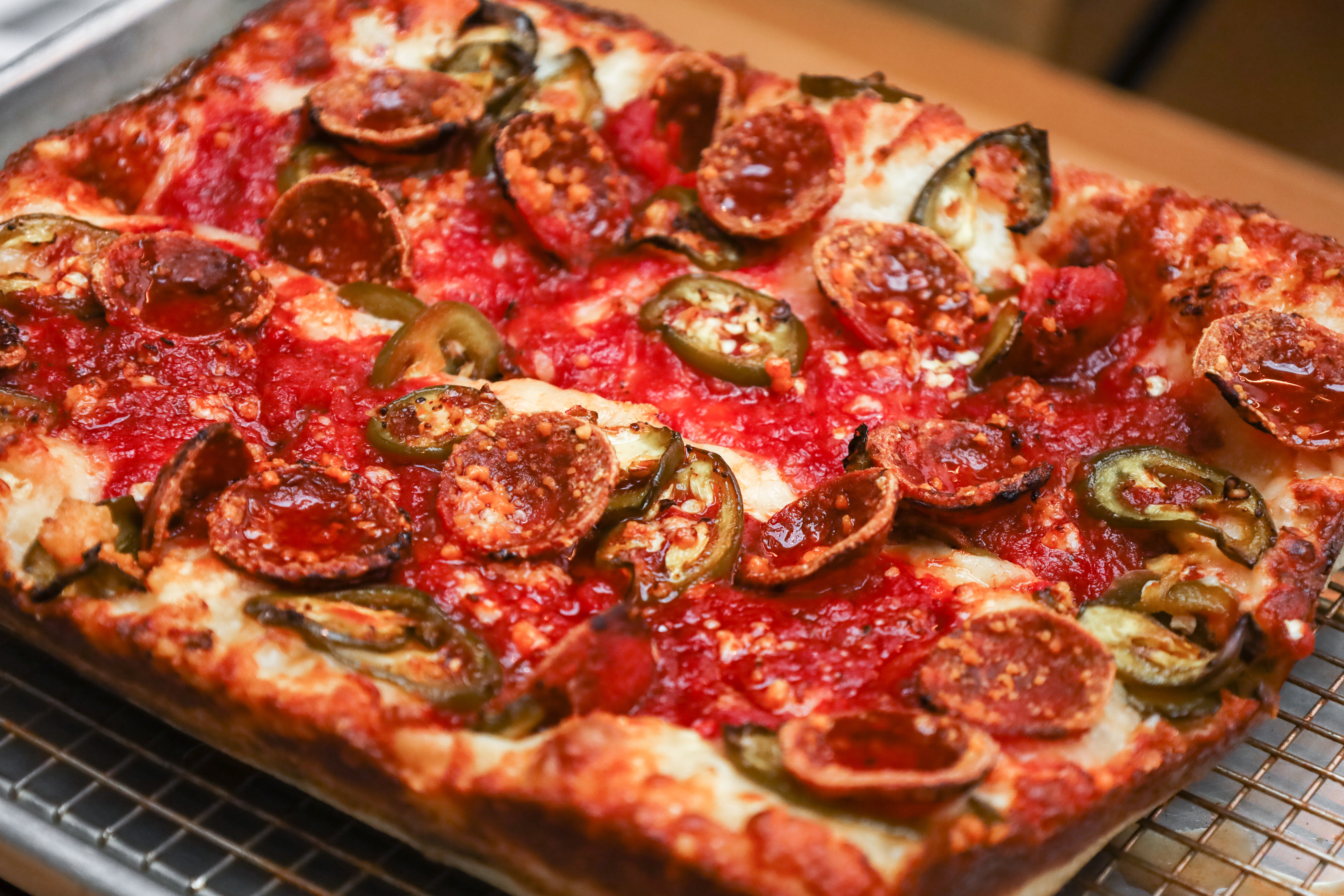 a pepperoni pizza sitting on top of a table