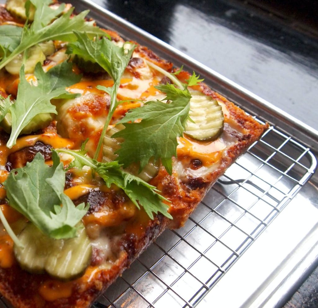 a pizza sitting on top of a pan