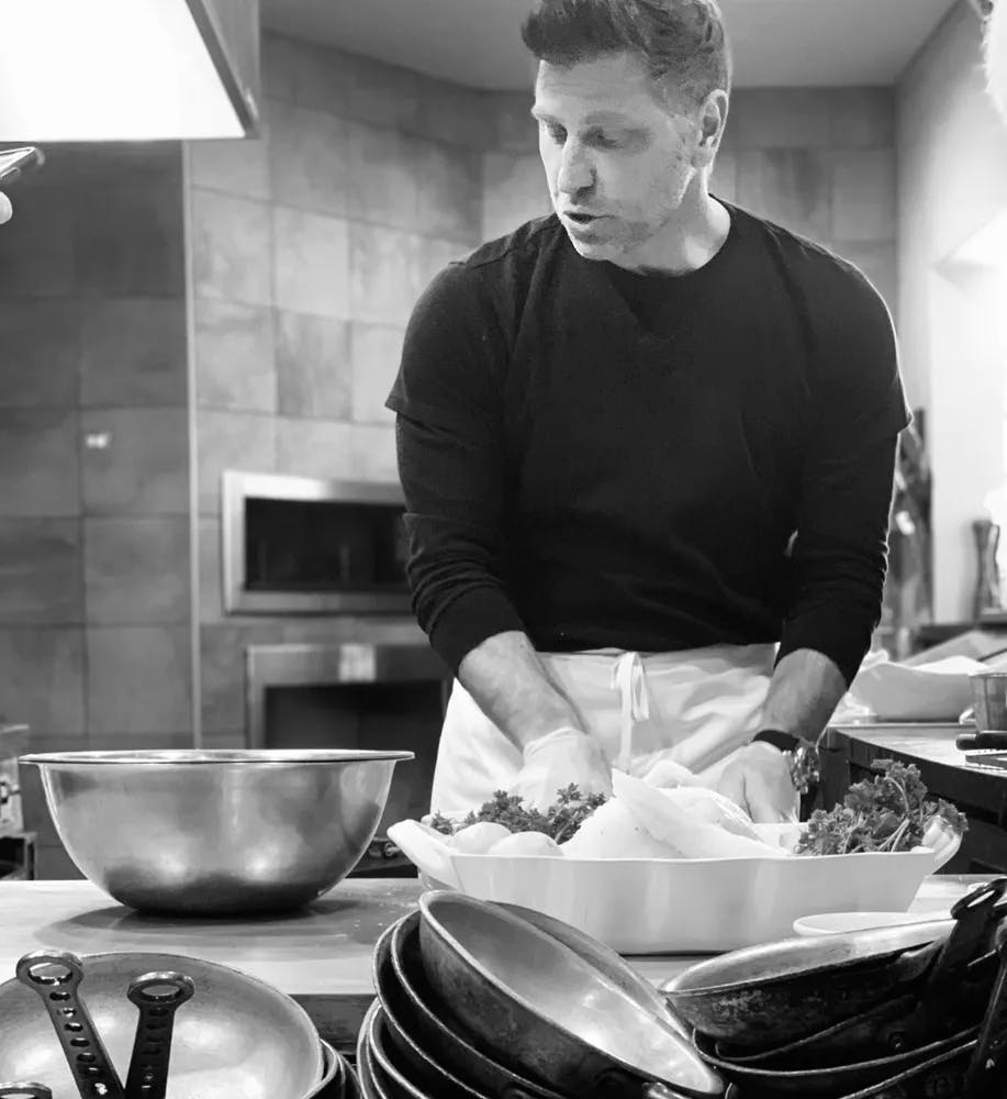 a person cooking in a kitchen preparing food