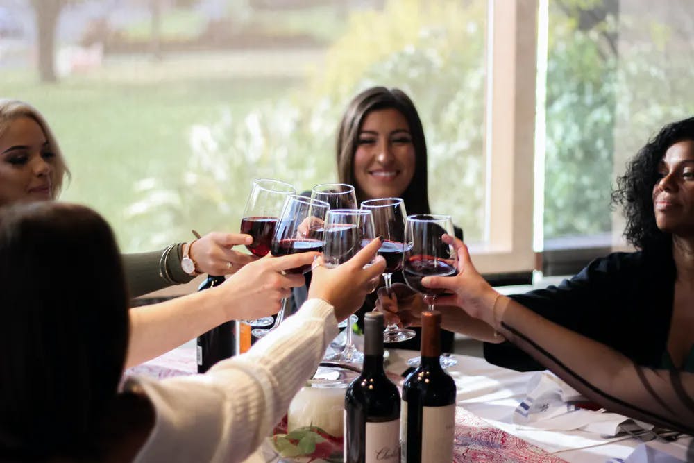 a group of people holding wine glasses