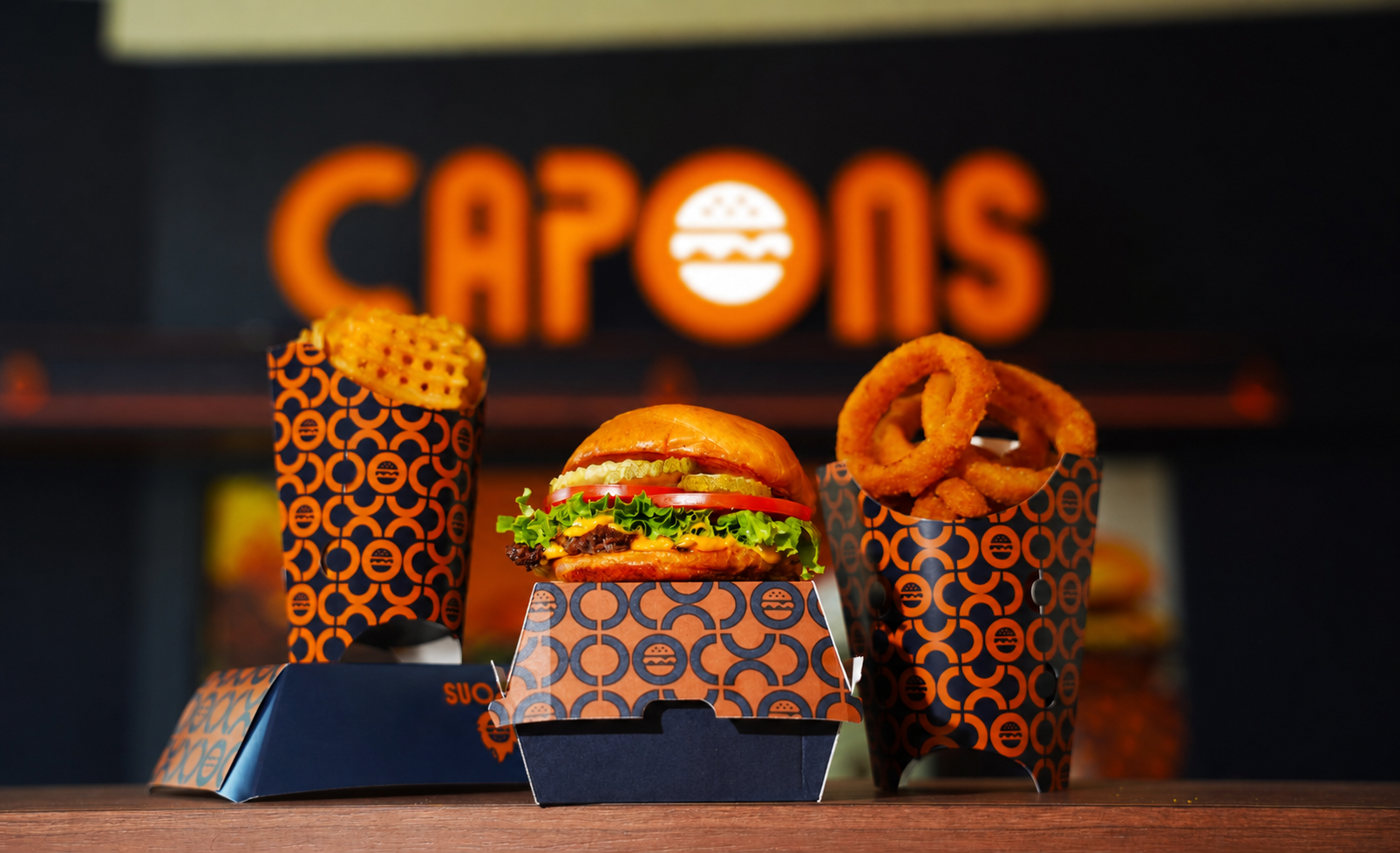 a group of burgers and fries in boxes