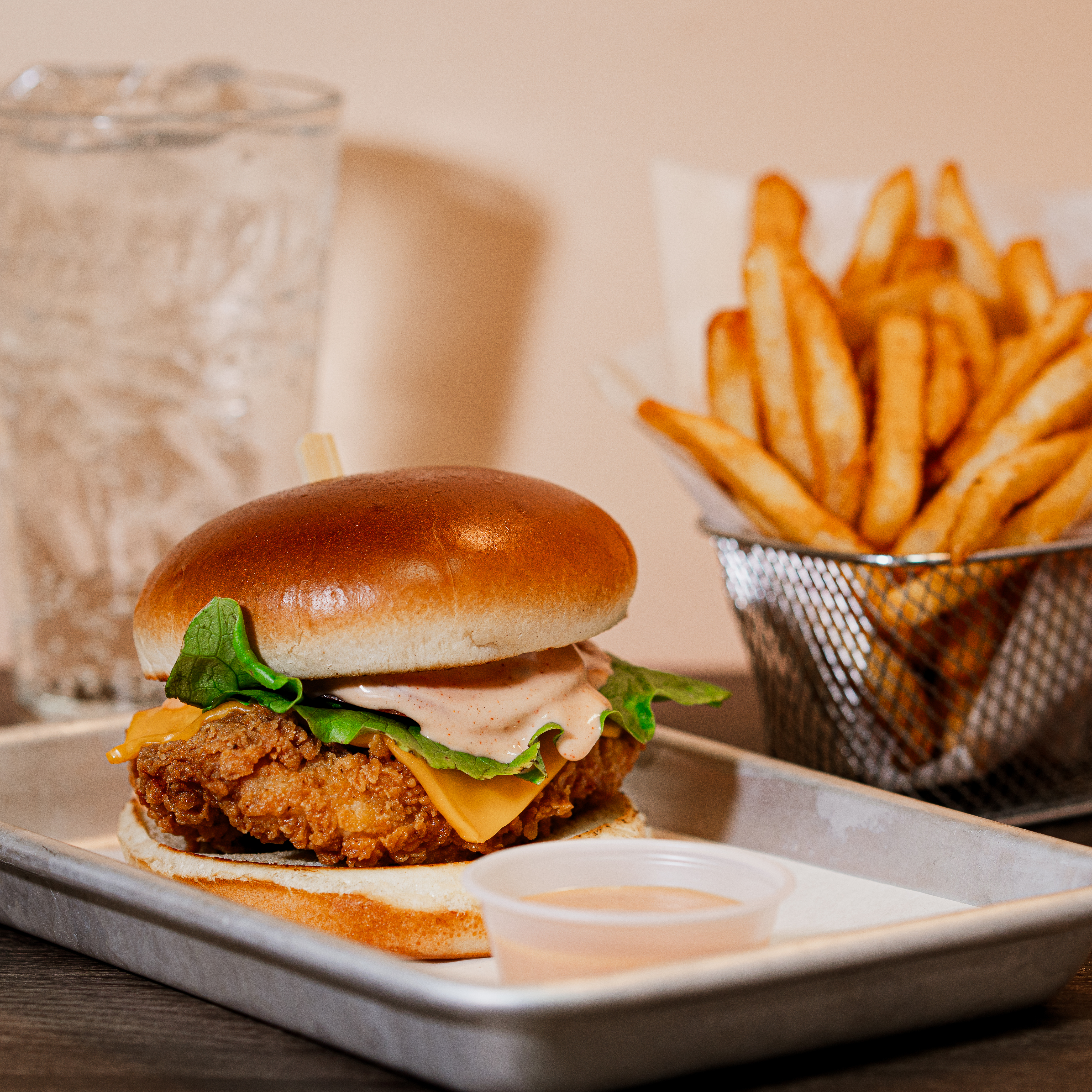 a sandwich sitting on top of a plate of food on a table