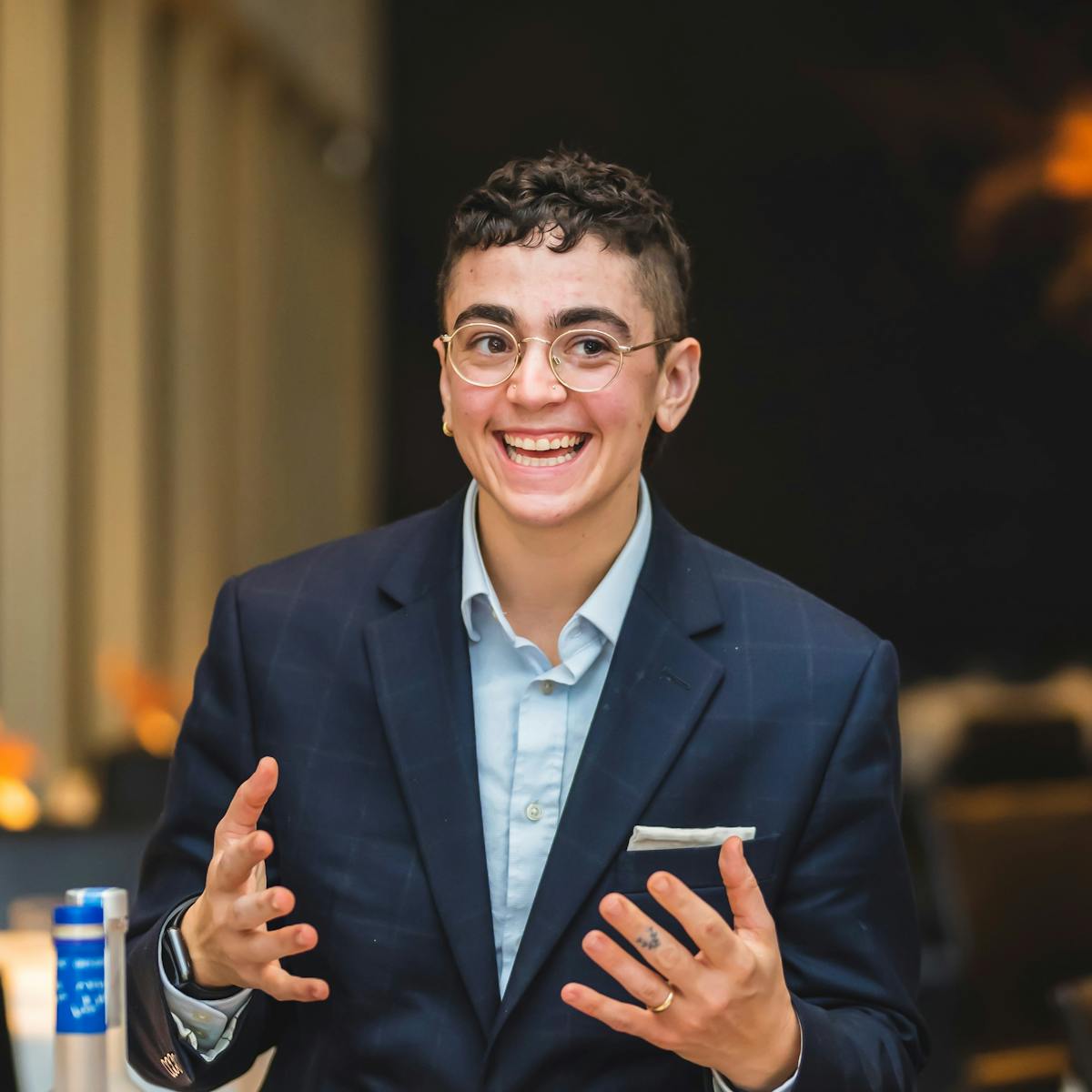 a man wearing a suit and tie talking on a cell phone